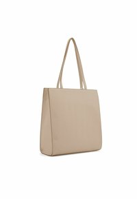 Sac fourre-tout beige avec une surface lisse et unie, de forme rectangulaire et deux longues poignées. Design minimaliste sans embellissements ni motifs.