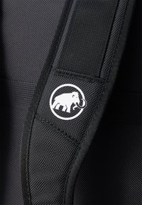 Black fabric strap featuring a textured weave and a prominent white circular logo of an elephant with tusks.