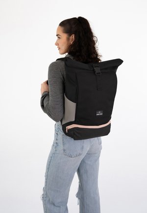 Black roll-top backpack with gray side accents and pink zipper detail. Made of durable fabric, featuring adjustable straps and a modern design.