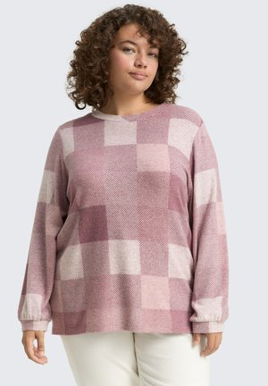 Chemise à manches longues dans des nuances de rose avec un motif à damier présentant des textures variées. Les poignets côtelés et un col rond complètent le design.