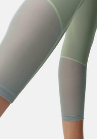 Világoszöld és kék átmenetes, magas derekú leggings, oldalán hálós panelek és elasztikus derékpánt a szépen illeszkedő fazon érdekében.