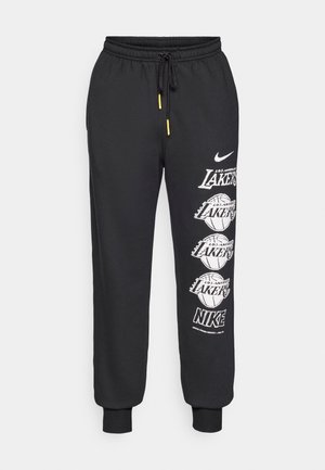 Zwarte sweatpants van zacht materiaal, met een verstelbare tailleband met gele accenten en witte opdruklogo's aan de zijkant.