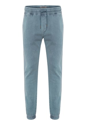 Lyseblå joggebukser laget av myk stoff, med elastisk midje og snor, sidelommer og avsmalnede mansjetter.