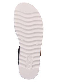 Semelle de chaussure en caoutchouc blanc avec un motif ondulé texturé, arborant une marque. Le côté présente un dessus sombre et un accent tissé près du talon.