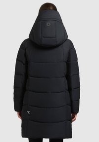 Sort pufferjakke med høj krave og hætte. Har quiltede sektioner, et cirkulært logo på ryggen og et side-tag. Glat tekstur.