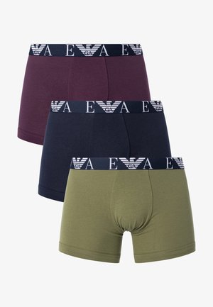 Three pairs of boxer shorts in dark burgundy, navy, and olive green. Each features a navy elastic waistband with a white logo design.