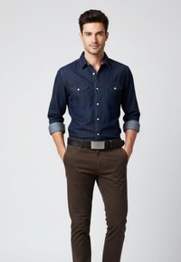 Dark denim button-up shirt with two chest pockets, rolled sleeves, paired with brown fitted trousers and a black belt featuring a silver buckle.