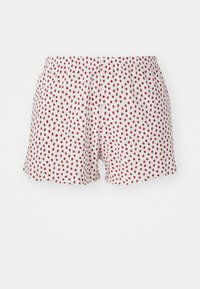 Short en tissu blanc avec un motif de fraises rouges répété. Taille élastique, coupe droite et bords festonnés. Matériau léger.