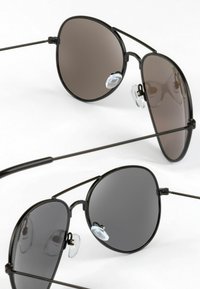 Black aviator sunglasses with tinted lenses, thin metal frame, and adjustable nose pads. Two pairs shown with varying lens shading.