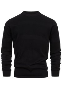 Musta neulepaita, jossa on teksturoitu kuvio, pyöreä pääntie, pitkät hihat ja resorit hihansuissa. Sileä, lämmin kangas.