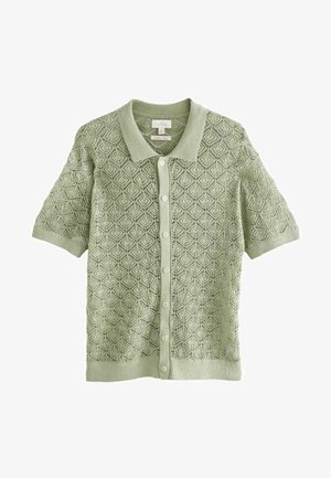 Cardigan scurt cu mânecă scurtă de culoare verde, cu un model texturat în diamant, având un guler și șase butoane pe față. Realizat dintr-un material moale.