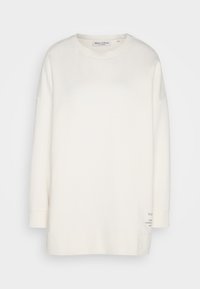 Sweat-shirt à manches longues, blanc cassé, col rond, avec un petit texte imprimé près de l'ourlet inférieur côté droit.