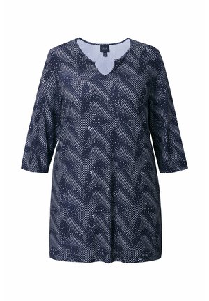 Marineblauw tuniek met een getande halslijn, driekwartmouwen en een patroon van witte stippen en golvende lijnen. Zachte, lichte stof.