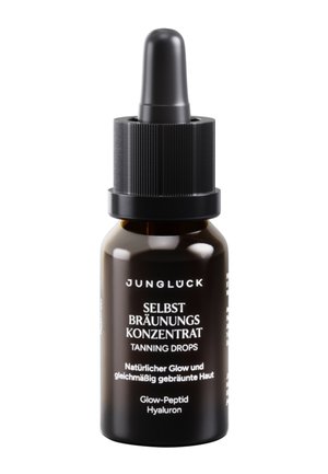 Dark glass bottle with black dropper cap labeled "Junglück Selbstbräunungskonzentrat Tanning Drops" for natural, even tan and glow.