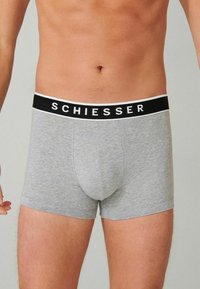 Gray cotton boxer briefs with a black waistband featuring the word "SCHIESSER" in white. The fabric has a smooth texture and fitted design.