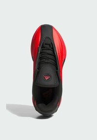 Lace-up sneaker featuring a black mesh and rubber upper with red synthetic accents, rounded toe, textured surface, and branded tongue.