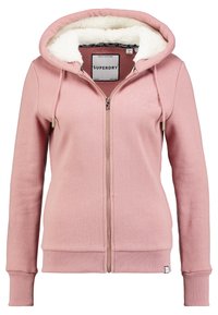 Sudadera con cremallera rosa, forro de felpa blanca, cordones, puños y dobladillo acanalados, y sutil logotipo bordado en el pecho.