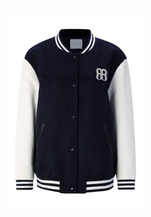 Tumesinine ja valge ülikoolistiilis jakk, milles on villasegu, soonilised varrukasuu- ja ääreosad, tõmblukuga kinnitamine, tikitud logo ja küljetaskud.