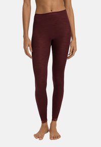 Bordeaux ribbed legging met een brede tailleband en kantafwerking bij de enkels, gemaakt van een zachte, rekbare stof.