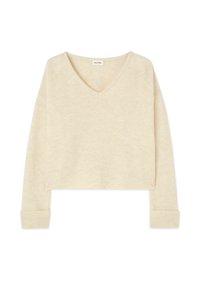 Pull cropped couleur crème avec un col en V, des manches longues et des poignets côtelés. Fabriqué en tissu doux et texturé. Design simple sans motifs.