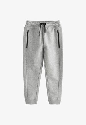 Lysegrå joggingbukser med elastisk talje, sort snøre, sidelommer med lynlås og ribstrikkede manchetter ved anklerne.