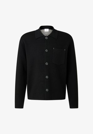 Schwarze Wolljacke mit Knöpfen, einem breiten Kragen, Brusttasche und sechs Frontknöpfen. Glatte Textur, taillierte Form, minimalistische Gestaltung.