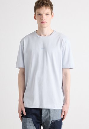 Light blue cotton t-shirt with a crew neck and short sleeves, featuring a subtle logo embroidered on the chest. Textured fabric finish.