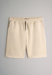 Beige Sportshorts mit elastischem Bund, Kordelzugverschluss, zwei Seitentaschen und glattem, leichtem Stoff.