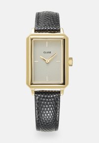 Quadratische goldfarbene Uhr mit einem strukturierten schwarzen Lederarmband. Graues Zifferblatt mit minimalistischen Markierungen und einem dezenten Markenlogo. Elegantes Design.