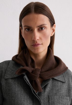 Brown knitted scarf tied around the neck, worn over a gray, pinstriped jacket with a collar and front pocket, against a white background.