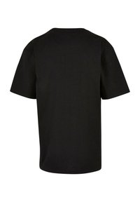 Svart kortärmad T-shirt i bomull. Har en klassisk rundad halsringning och en ren, sömlös ryggdesign utan mönster eller utsmyckningar.