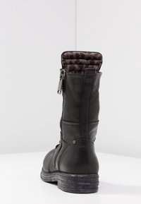 Czarny skórzany botek do połowy łydki z bocznym zamkiem, wyściełanym wewnętrznym podszyciem o fakturze oraz gumową podeszwą, ukazany z tyłu na białej powierzchni.