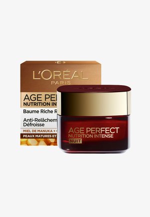 Crème de nuit L'Oréal Age Perfect Nutrition Intense dans un pot en verre rouge foncé avec un couvercle doré. L'emballage présente un design en or et en nid d'abeille.