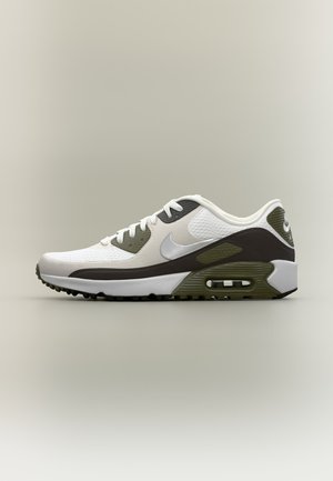 Baskets Nike Air Max blanches et vert olive avec détails noirs sur la semelle intermédiaire, coussin d'air visible et lacets blancs sur fond neutre.