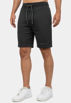 Zwarte katoenen shorts met een elastische tailleband, trekkoordsluiting en zijlogo-borduring. Knie-lang met een gladde textuur.