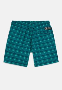 Turkizne kopalne hlače s kružnim vzorcem, elastičnim pasom in dvema stranskima gumboma. Imajo zadnji žep z blagovno znamko.