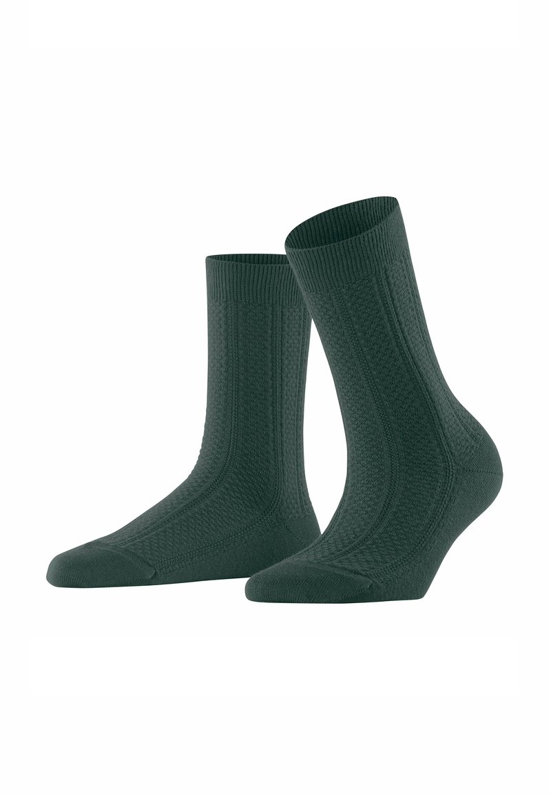 Chaussettes en coton vert foncé avec un haut côtelé, un corps texturé et un renfort au niveau des orteils. Longueur cheville avec un motif distinctif et une finition lisse.