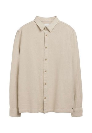 Chemise beige à manches longues, boutonnée, en tissu texturé avec col classique, étalée à plat sur un fond blanc.