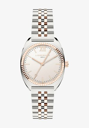 Sølv- og rosaguld rustfrit stål ur med et rundt urkasse, minimalistisk urskive og tallet "XII", der har et dobbelt-tone led-bracelet.