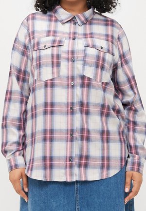 Long-sleeve button-up shirt with pink, blue, and white plaid pattern, featuring two chest pockets with flaps worn over blue denim.