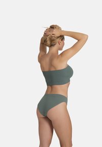 Green ribbed strapless top paired with matching high-waisted bikini bottoms. Smooth texture, seamless design, and a fitted silhouette.