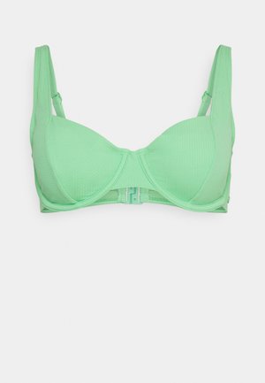 Hellgrüner BH aus strukturiertem Stoff, mit geformten Cups, verstellbaren Trägern und einem Haken- und Ösenverschluss auf der Rückseite.