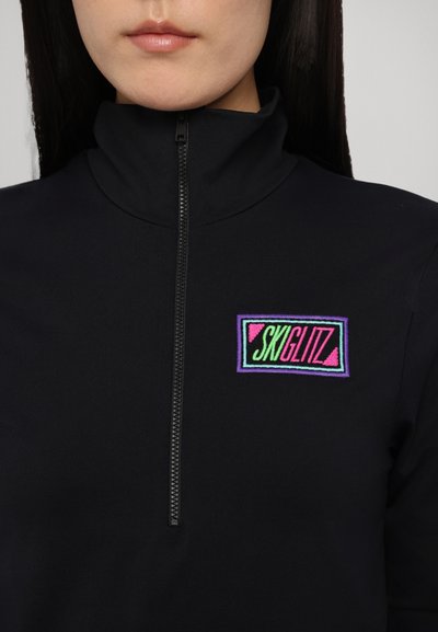 Black zip-up fleece with high collar, featuring a multicolored embroidered "SKIGLITZ" logo on the chest. Smooth texture and fitted design.