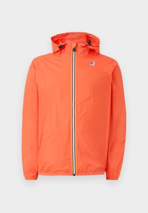 Orange lightweight jacket with a front zipper, drawstring hood, elastic cuffs, and a logo patch on the chest. Features a striped zipper accent.
