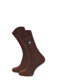Brązowe bawełniane skarpetki o gładkiej fakturze z prążkowanym ściągaczem i małym turkusowym logo po bokach.