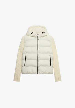 Gesteppte Steppjacke in Off-White mit Kapuze, schwarzen Reißverschlüssen und strukturierten Strickärmeln mit Zopfmuster.