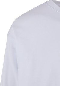 White cotton t-shirt with a round neckline, short sleeves, and a smooth, even texture. No visible patterns or accents.