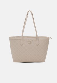 Beige tote bag with quilted pattern, dual handles, V-shaped accent on front, and top zipper closure. Smooth texture. Rectangular shape.