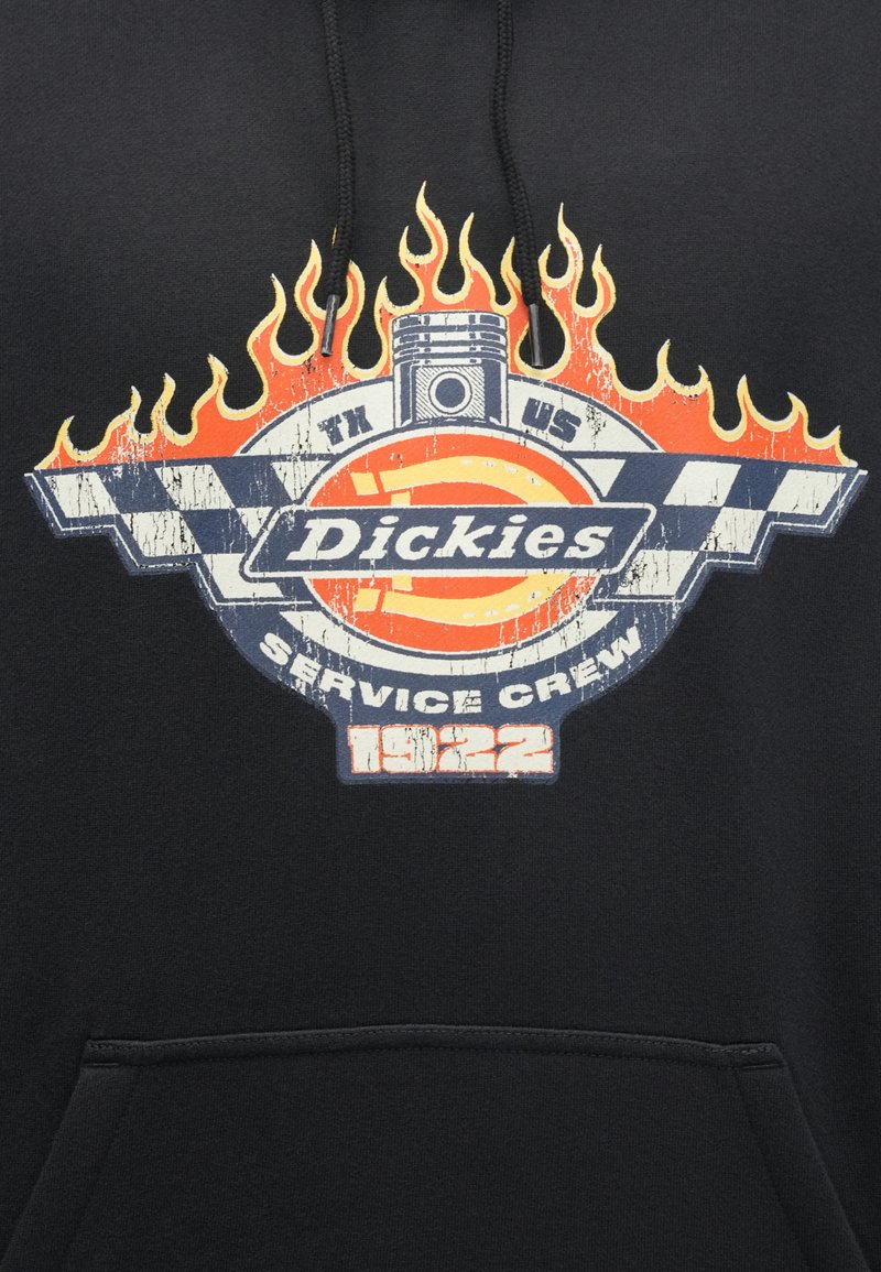Black hooded sweatshirt featuring a graphic design with red flames, blue checkered flag accents, and the text “Dickies Service Crew 1922.”