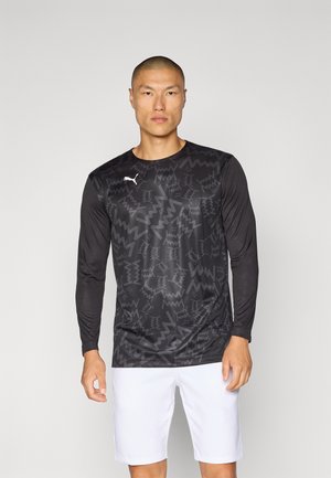 Black long-sleeve sports shirt with geometric patterns, made of lightweight material. White logo on the left chest, paired with white shorts.